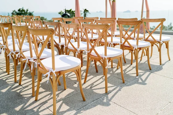 Folding Lawn Chair with white seat during wedding venue preparation, Samui island, Thailand