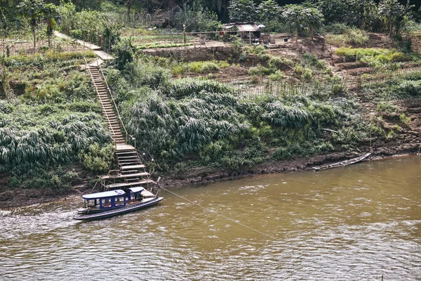 Simple life of agricultural in Laotian along with Mekong river with boats for transportation