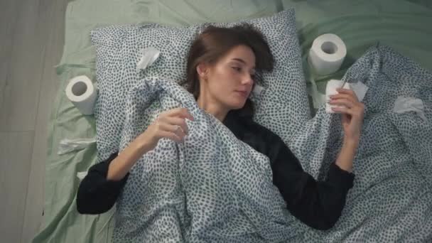 Chora Dziewczyna Leży Łóżku Pod Kołdrą Dmucha Nos Papier Toaletowy — Wideo stockowe