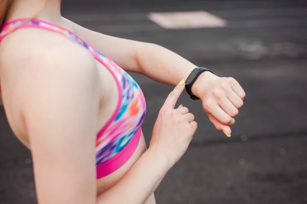 woman watching to her fitness tracker
