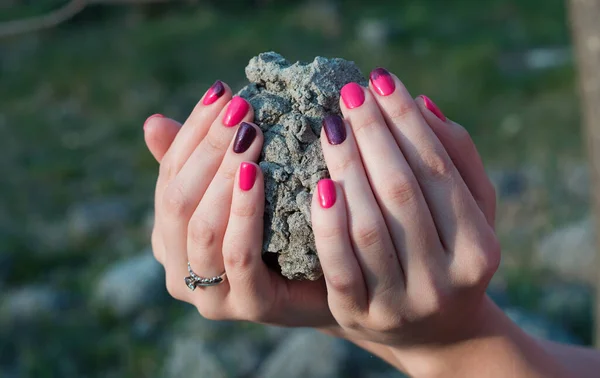 Beautiful hands girl with bright manicure close-up. The sphere of fashion and beauty, care of hands. A cobble in women \'s hands with a glamorous manicure
