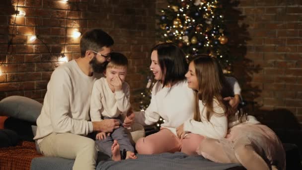 Happy family in the bedroom on Christmas evening — Stock Video