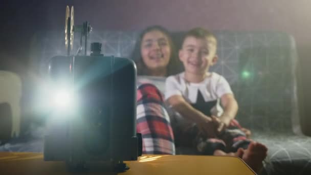 Kids watching a cartoon on an old movie projector — Stock Video