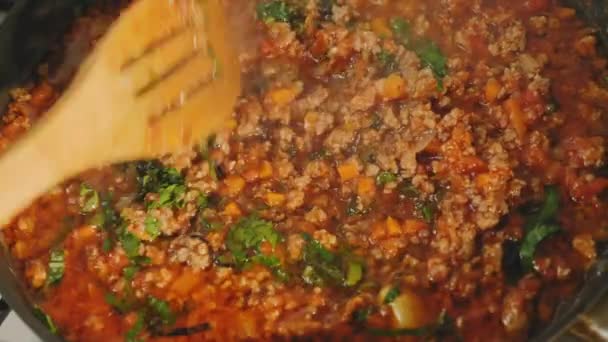 Cooking and stirring bolognese sauce in pan — Stock Footage Cooking and stirring bolognese sauce in pan Royalty Free Stock Footage