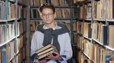 Portrait of handsome teenage boy in the library