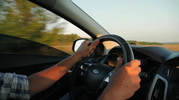 Closeup of man hands on steering wheel driving car — Stock Photo, Image