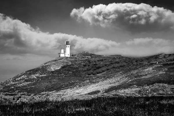 The beautiful white tower on Channel Island with a dramatic deep blue sky.