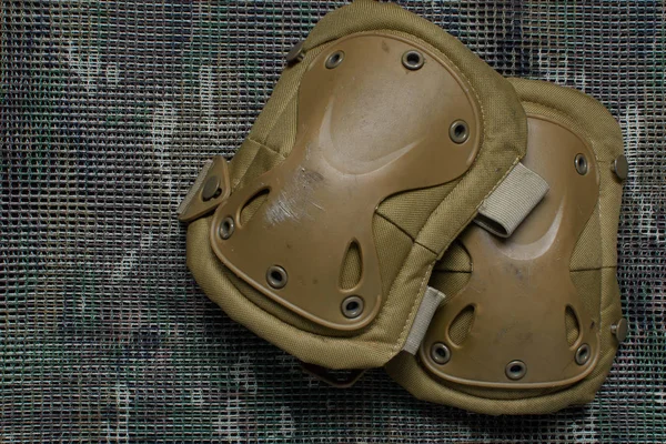 Tactical knee pads lies on a multicam background