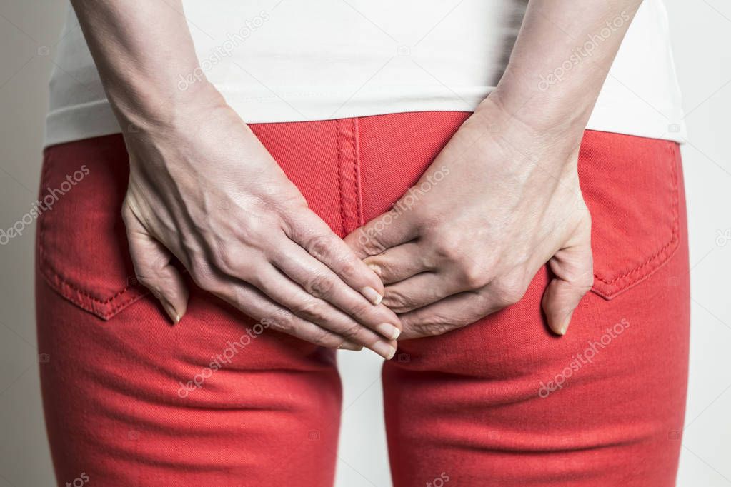 Woman holding her bum and pain in the butt. Diarrhea .