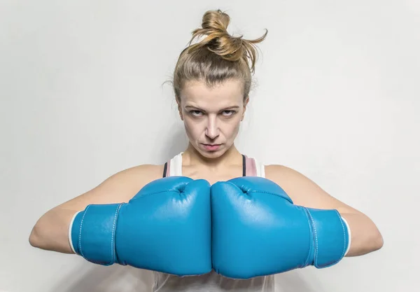 Woman in boxing gloves. Fitness. Self-defense.
