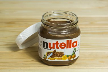 Kyiv, Ukrayna - 5 Ağustos 2017 Nutella Fındık kavanozu. Fındıklı kavanoz açıldı. Tahta arka planda Nutella ve kaşık.