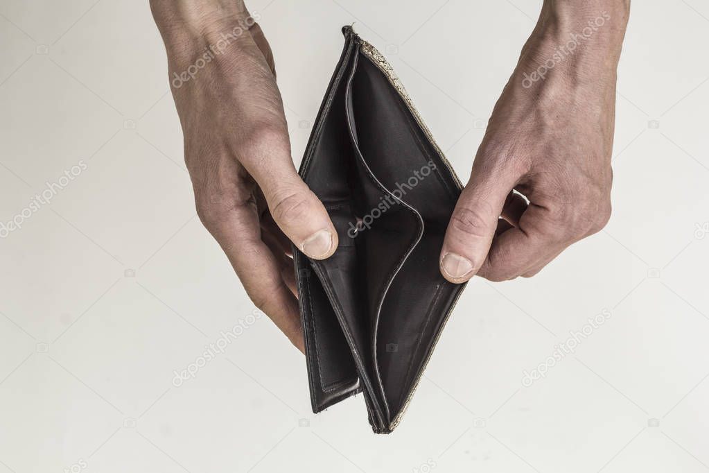 Empty purse in hands on a white background. The concept of poverty, bankruptcy.