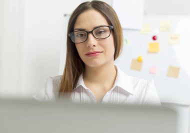 Portrait of a smiling woman financier working at a computer. 