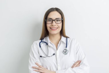 Portrait of a smiling and beautiful female doctor in a white coat. 