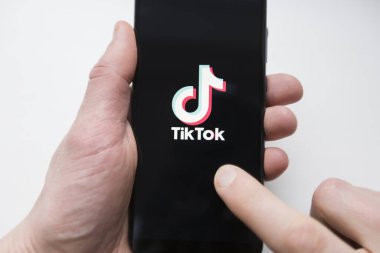 Ukraine, Kyiv - Dec. 22th, 2019 : Tik Tok logo on the phone screen. Application for creating short videos.