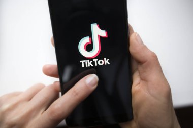 Ukraine, Kyiv - Dec. 22th, 2019 : Tik Tok logo on the phone screen. Application for creating short videos.