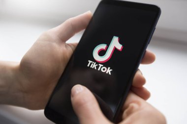 Ukraine, Kyiv - Dec. 22th, 2019 : Tik Tok logo on the phone screen. Application for creating short videos.