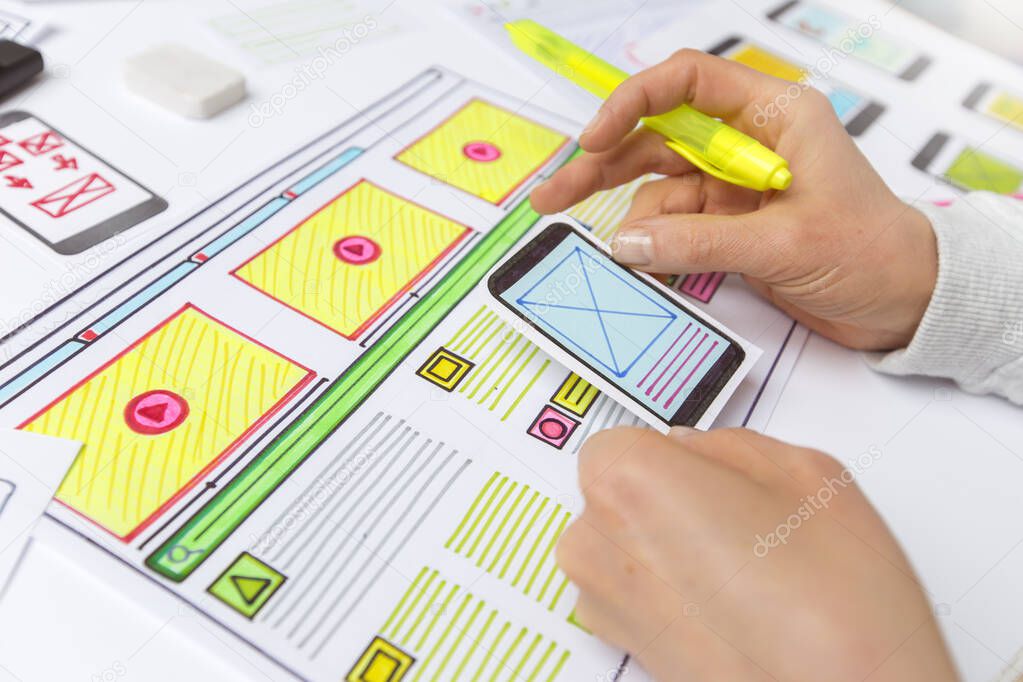 Designers develop website applications. Designers draw sketches of the interface. User experience concept.