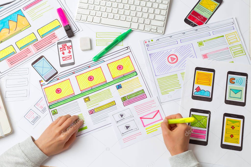 Designers develop website applications. Designers draw sketches of the interface. User experience concept.