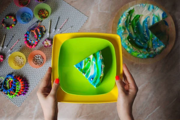 Doğum günü pastası. Festival kek. Kek üzerine bir tabak eller içinde. Kek üzerine mermer masa üstü görünümü.