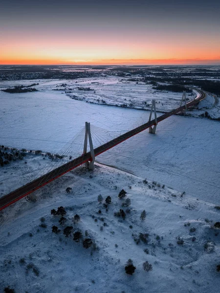 sunset in winter. Bridge over river. the sun will want. river in ice