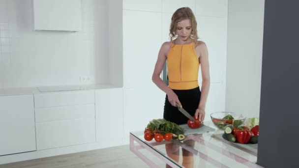 Jonge Vrouw Snijdt Rode Peper Voor Groentesalade Witte Moderne Keuken — Stockvideo