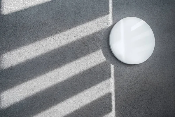 Shadow and light through blinds window on tiled wall. Abstract form morning light and shadow on the wall.