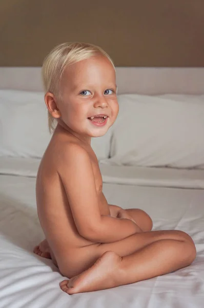 Niño Sienta Cama Ríe Niño Sonríe Vista Lateral Cuerpo —  Fotos de Stock