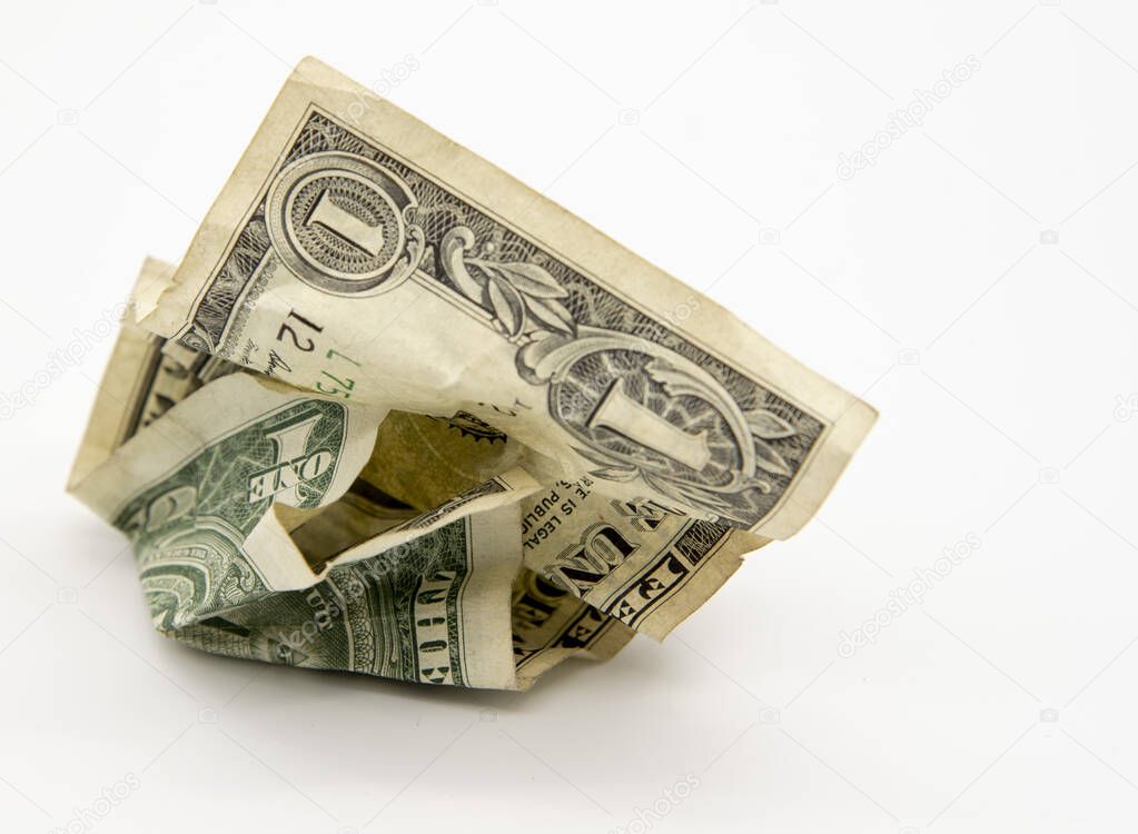 One crumpled dollar on a light background.