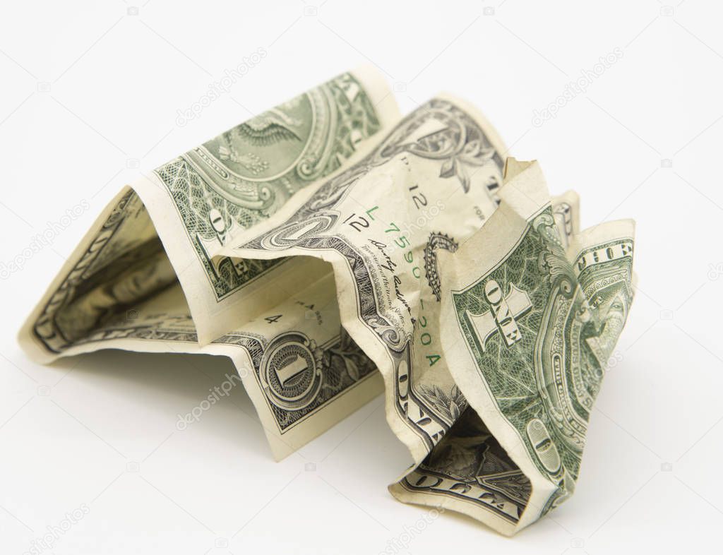 Two wrinkled dollars on a light background.