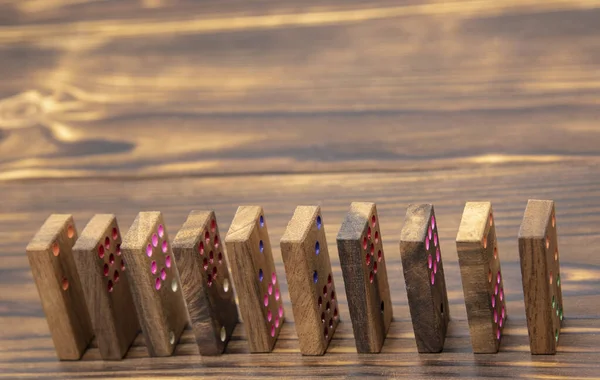 Чипсы Домино помещаются один за другим на деревянный стол . — стоковое фото