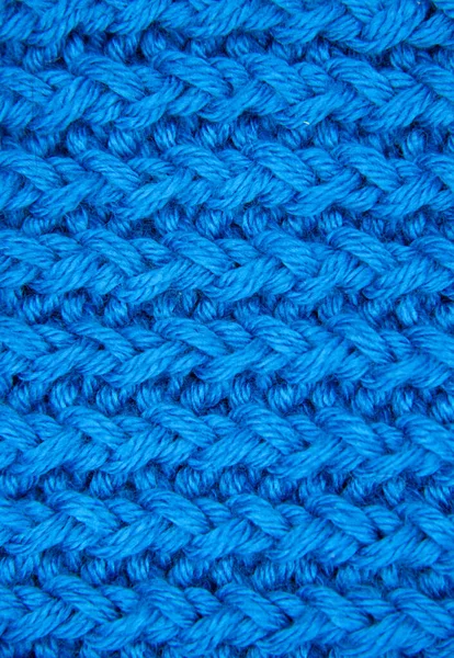 The texture of a knitted woolen fabric blue. — Stock Photo, Image