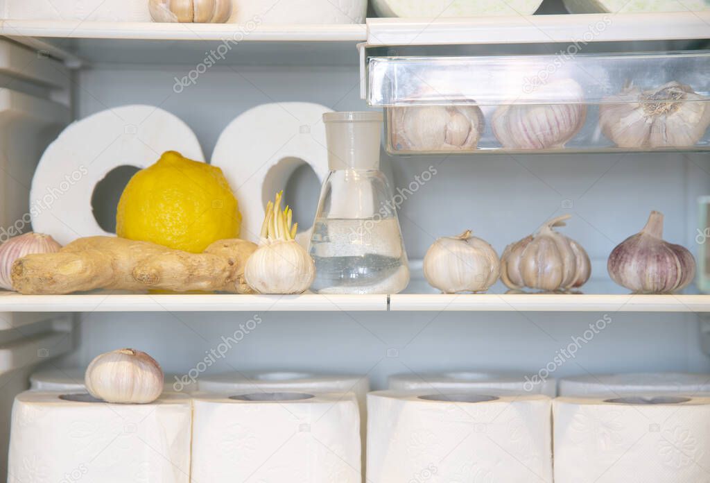 A supply of toilet paper , stored in the refrigerator with garlic, lemon , and ginger. A funny photo that symbolizes the panic of the coronavirus epidemic.
