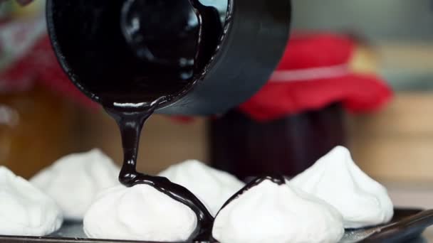 Pouring chocolate on meringues super slow motion — Stock Video