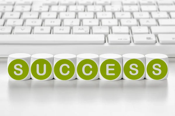 Letter dice in front of a keyboard - Success — Stock Photo, Image