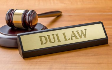A gavel and a name plate with the engraving DUI Law clipart