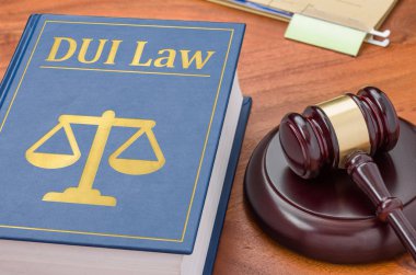 A law book with a gavel - DUI Law clipart