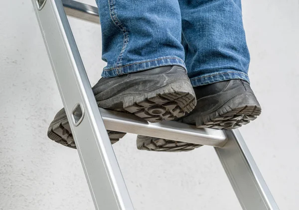 Bir adam bir merdiven standları — Stok fotoğraf