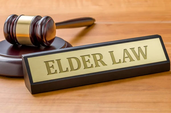 A gavel and a name plate with the engraving Elder law — Stock Photo, Image