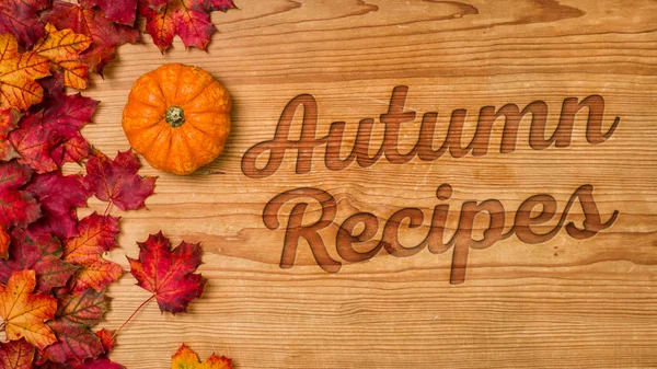 A wooden background with autumn foliage - Autumn Recipes — Stock Photo, Image