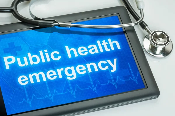 Surfplatta med texten Public health emergency på displayen — Stockfoto