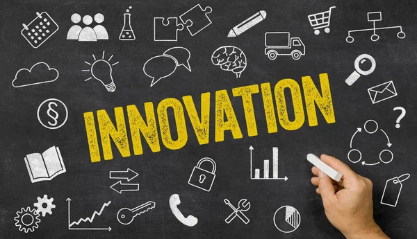 Innovation written on a blackboard with icons — Stock Photo, Image