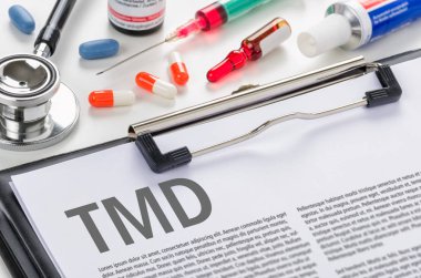 The diagnosis TMD written on a clipboard clipart