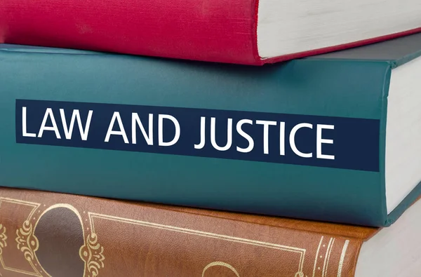 A book with the title Law and Justice written on the spine — Stock Photo, Image