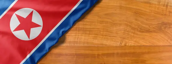 National flag of North Korea on a wooden background with copy sp