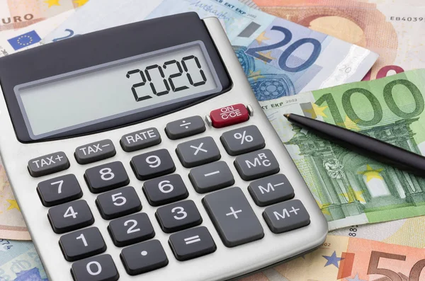 Calculator with money and a pen - 2020 — Stock Photo, Image