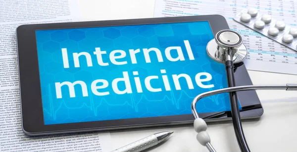 The word Internal medicine on the display of a tablet — Stock Photo, Image