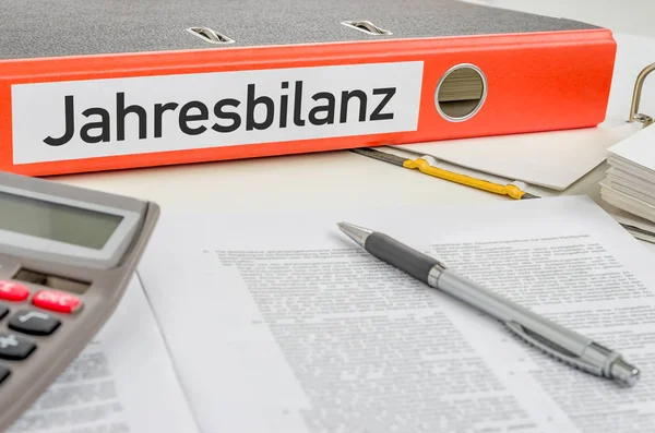 An orange folder with the label Annual balance - Jahresbilanz (G — Stock Photo, Image