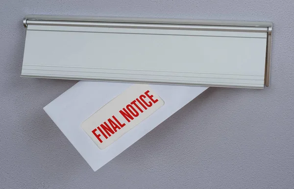 A letter in a mail slot - Final Notice — 图库照片