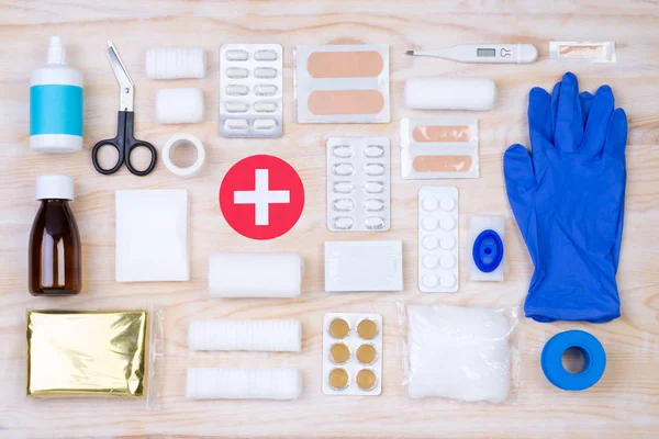 First aid kit on wooden background — Stock Photo, Image